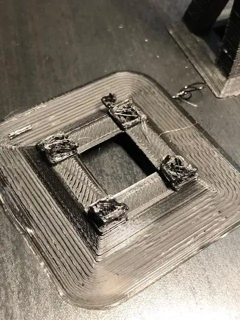 Close-up photo of the base of a printed model with printing errors