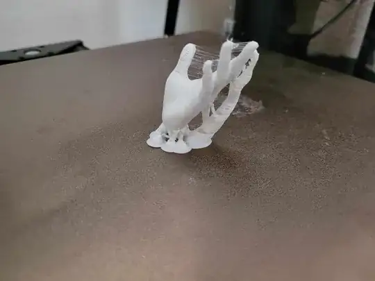 Photo of a 3D printed model of a hand with stringing between the fingers and gaps on the fingers Photo of a 3D printed model of a hand with stringing between the fingers and gaps on the fingers