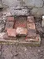Chicken wire is laid on top of crushed bricks for base.