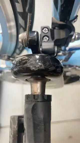 Close-up view of the end of the right crank-arm showing a scraped area about 1cm square where it has apparently contacted the ground