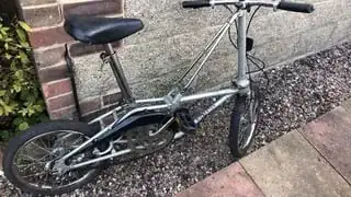 1980s Bickerton-branded DAHON folding bike in silver, showing the Bickerton branding and the head tube support.