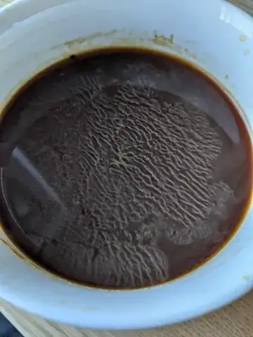 Coffee with white stuff floating in it