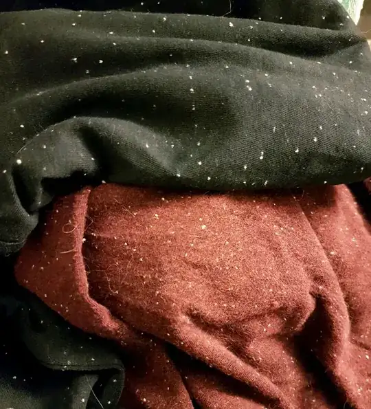 two pieces of jersey fabric, black and red, with white specks