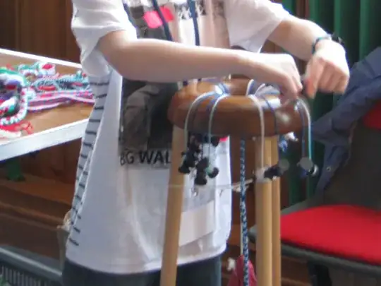 young boy braiding on a kumihimo frame