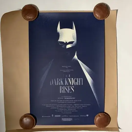 using 4 weighted leather paper weights to lay flat a rolled poster