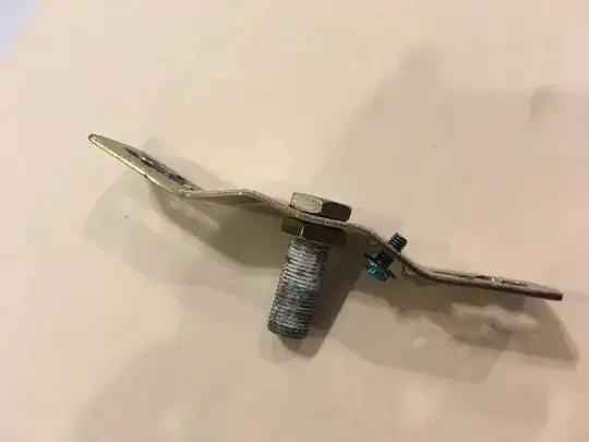 side view of mounting bracket/strap and nipple with nuts and grounding screw