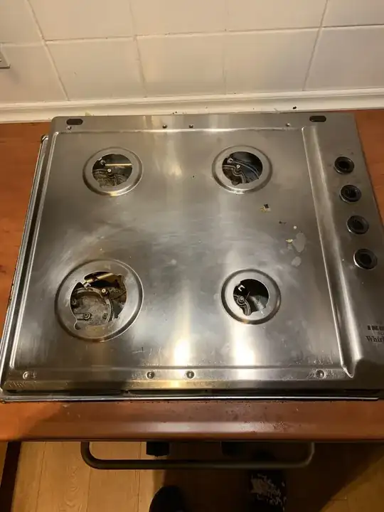 gas stove with the cover roughly covering it