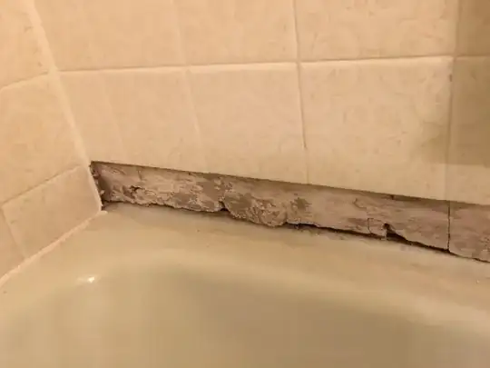 Another close-up of the same stretch of damaged drywall, after removing all the drywall paper, allowing the gypsum to dry out for 12 hours, and then brushing off the brown deposit.  The board is cracked and pitted especially near the bottom but might not be completely ruined.