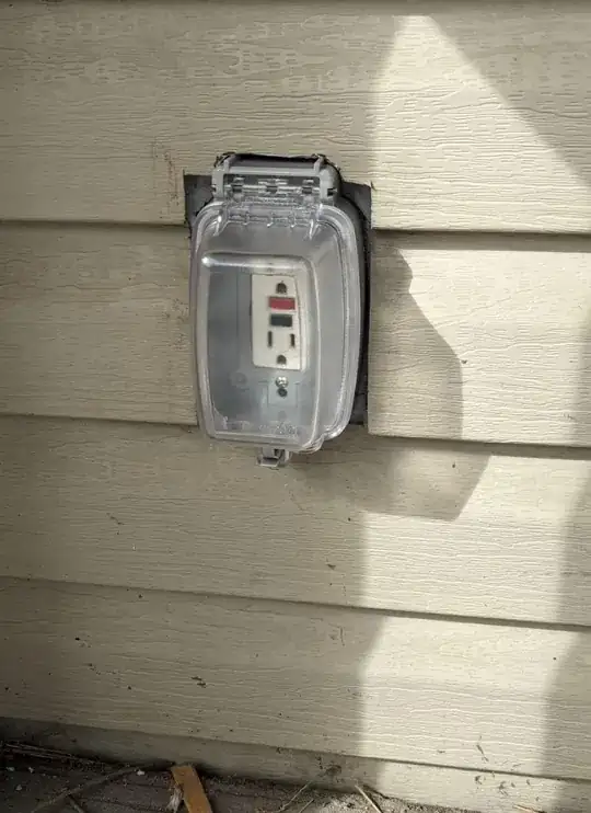 a picture of the new plug cover, showing the gap between the original square cutout in the vinyl siding and the new plug cover