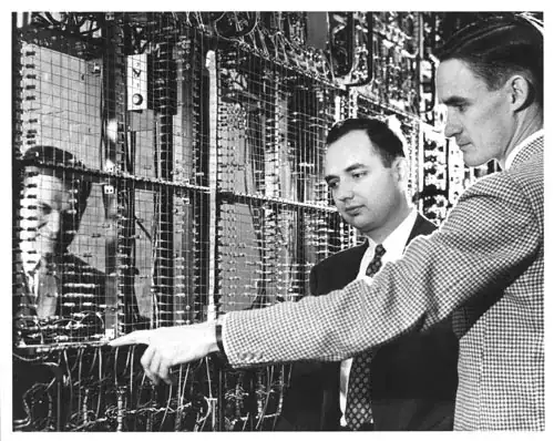 two men pointing at a large diode matrix
