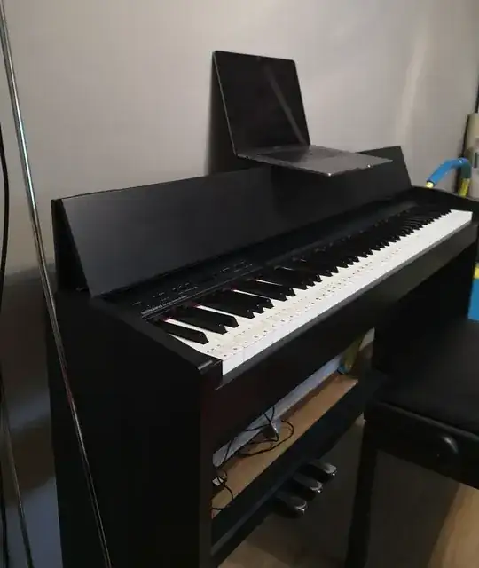 laptop sitting on piano