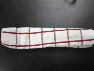 The same towel, wrapped around the knife (unseen).