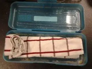 The wrapped up knife from the last image, placed into a plastic pencil case.