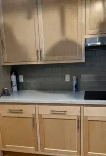 Click photo for full size. kitchen counter with cabinets above and below