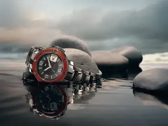 Watch reflected in water with stones