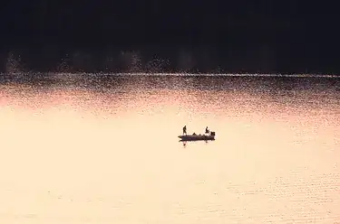 boat on lake at sunset