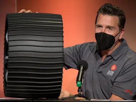 >Adam Steltzner, Perseverance chief engineer, shows a rover wheel during a NASA Perseverance rover mission engineering and technology overview