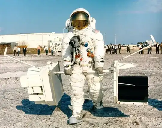 Apollo 13 Commander Jim Lovell carrying a plutonium battery and scientific equipment during training (NASA)
