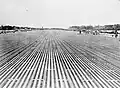 View of the main runway at RAF Changi, Singapore, soon after its completion. The runway constructed from 276,680 pierced steel sheets was 2,000 yards in length and 50 yards wide was able to take the largest aircraft then in service with the RAF.