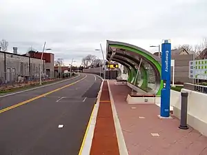 A bus station platform with a curved canopy