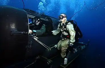 A Navy diver and special operator from SEAL Delivery Team (SDV) 2 perform SDV operations with the nuclear-powered guided-missile submarine USS&nbsp;Florida