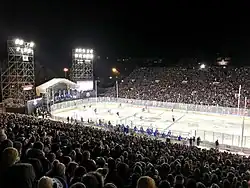 A football stadium with a hockey rink in the center